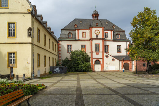 Koblenz, Germany - 16 September 2025: View of the Alter Kaufhaus, its red trim contrasting against the pale facade, standing proudly amidst the geometric precision of the cobblestone square.