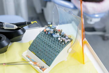 Dental bur set and polishing tools prepared for tooth treatment in modern clinic