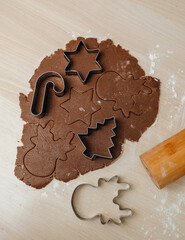 Rolled cookie dough with metal cutters on a baking table