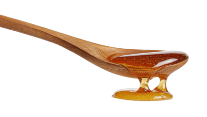 A wooden spoon holding viscous golden liquid, dripping onto a surface