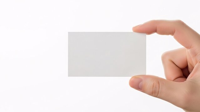 A hand holding a small square piece of paper or card