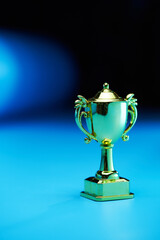 small trophy against blue background.