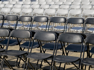 Fototapeta premium Outdoor rows of folding chairs set up for an event