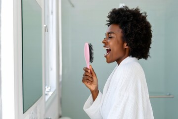 Young Woman Brushing Eyelashes in Bathroom - Self-Care Routine