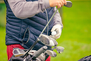 Golfer takes out the stick from his bag