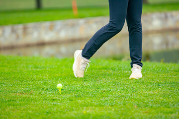 Golfer performs a strong golf shot to fairway