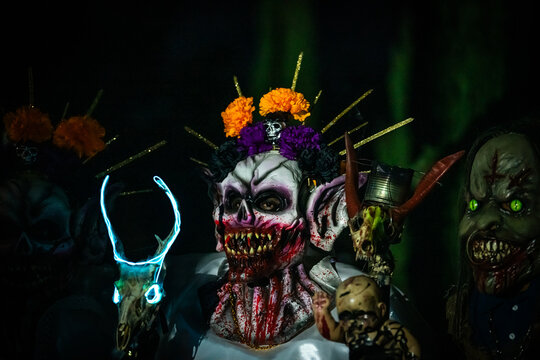 Santa Maria del Tule, Mexico - 03 November 2023: View of vibrant, grotesque masks at Day of the Death cementary, a macabre and colorful spectacle.