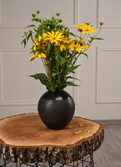 Jerusalem Artichoke Bouquet in Spherical Vase on Live Edge Table