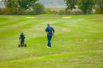 People, golfers enjoying on the golf course, playing together