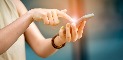 Girl is holding a smartphone in her hands closeup view.