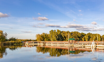 Fototapeta premium Calm lake with a dock and a small green building