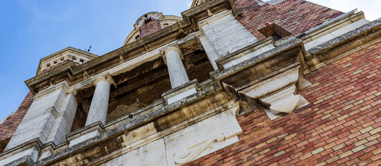 Brick building with a window and a white trim