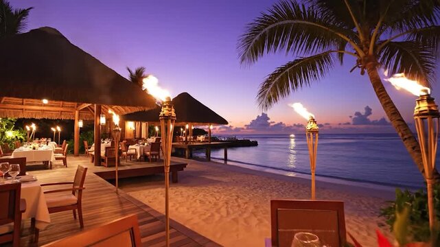 An elegant beachside restaurant setting at dusk with tiki torches and ocean views