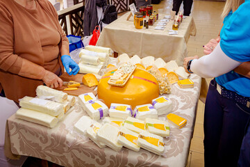 Various cheeses on the counter for sale