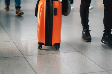 A suitcase in a red color closeup, a luggage at the airport.