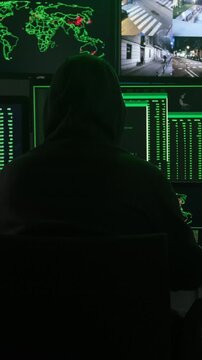Anonymous hooded hacker working on a computer cyberattack