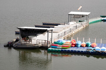 Colorful canoes docked on pier.