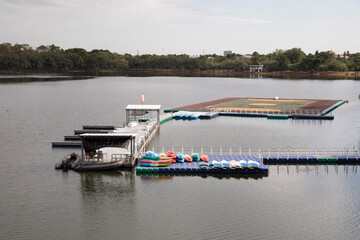 Floating sports field and kayaks on pier in public lake.