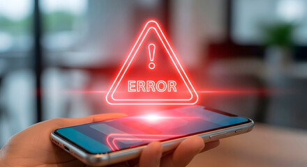 Hand holding a smartphone with a glowing red error triangle icon. Data problems, system failure, security breach concept for mobile device.