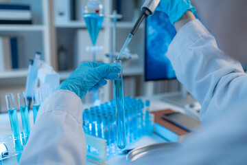 A chemistry researcher in a laboratory surrounded by scientific equipment and test tubes, representing innovation, scientific development, and modern medical research environment.