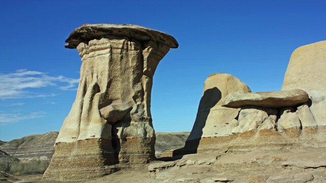 Hoodoos near Drumheller, Alberta, Canada .A hoodoo is a tall, thin spire of  sedimentary rock and volcanic rock formed by erosion . 