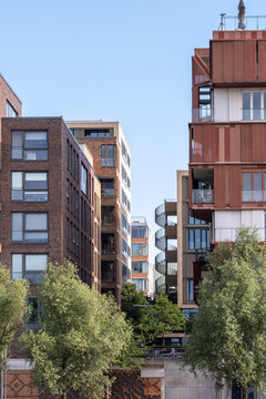 Urban architecture with green residential building, modern city exterior design, sustainable vegetation integrated into contemporary housing environment