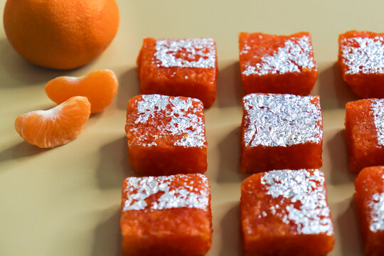 Nagpur Orange Barfi. Traditional Indian mithai made with milk solids and fresh Nagpur orange pulp. Soft, creamy fudge texture with tangy citrus flavor, inspired by India&rsquo;s Orange City, perfect for fes