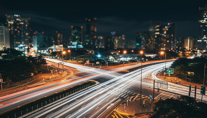 A Long-exposure Photograph Of A Busy City Intersection At Night, With Light Trails From The Traffic Creating A Sense Of Motion.