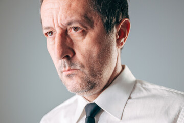 Thoughtful businessman looking back reflecting on mistakes