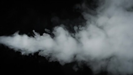 White wisps of vapor flowing, contrasted against a black background, diffused