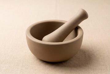 Traditional ceramic mortar and pestle for grinding spices, herbs, or ingredients in a kitchen or pharmacy setting