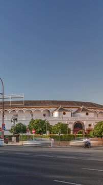 Plaza de Toros de la Real Maestranza de Caballeria de Sevilla timelapse hyperlapse. Historic bullring in Seville, Spain, known for its bullfighting festivals. Traffic passing in front of its facade