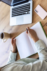 Remote work, window and writing with woman in home office for agenda, planning or research. Desk, notebook and view with freelance employee in apartment for schedule of small business startup.