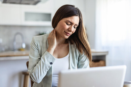 Woman, neck pain and stress with injury for overworked pressure, fatigue or strain in home. Female person, freelancer or remote work with sore shoulder or muscle tension for project deadline in house.