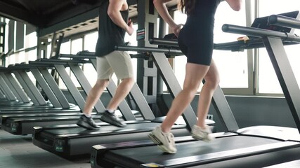 Caucasian Man and Hispanic Woman Striving for Physical Excellence treadmill.