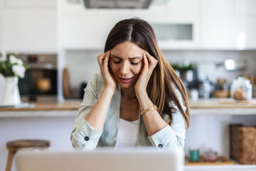 Headache, laptop and remote work with woman in living room of home for small business burnout. Computer, migraine and stress with freelance employee in apartment for startup error, fail or mistake.