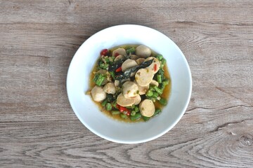 spicy stir fried chop pork and meatball couple slice yard long bean with basil on plate