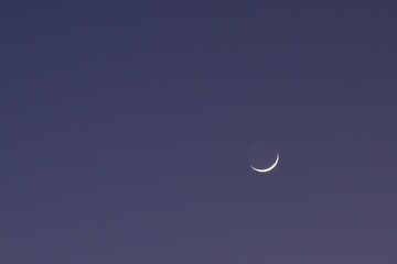 half moon floating on blue sky in twilight background 