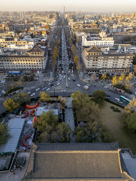 Aerial view of the bustling city with its grand buildings and tree-lined streets in the morning glow, Xi'An, Shaanxi, China.