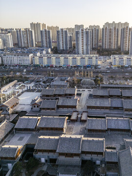 Aerial view of ancient rooftops juxtaposed against modern high-rise apartments, creating a striking contrast of history and progress, Datong, Shanxi, China.