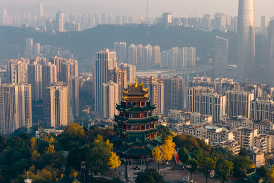 Aerial view of Hong'en Pavilion, a traditional Chinese pagoda, stands amidst a modern cityscape, with the soft morning light casting a golden glow over the scene, Chongqing, Hong&rsquo;en Pavilion, China.
