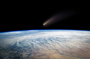 Comet, asteroid, meteorite flying to the planet Earth.  Glowing asteroid and tail of a falling comet threatening the safety of the Earth.  Elements of this image furnished by NASA. © Tryfonov