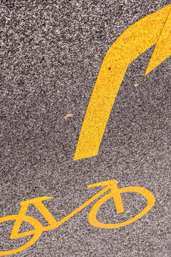 Bicycle symbol with direction signage on urban road highlighting cycling infrastructure mobility and transportation guidance