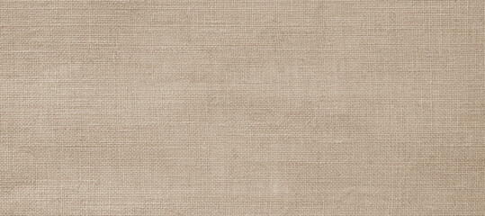 Jute hessian sackcloth woven hemp burlap fibre fabric textile texture background in sepia cream old aged brown color