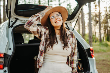 Naklejka premium Woman enjoying road trip freedom in a forest