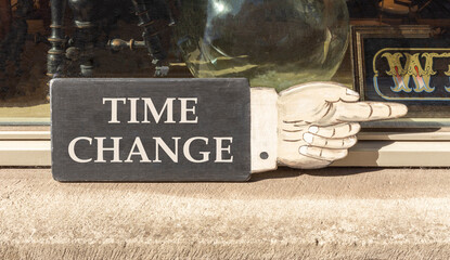Time change symbol. Concept word Time change on beautiful black wooden hand with finger. Beautiful shop display background. Business time change concept. Copy space.