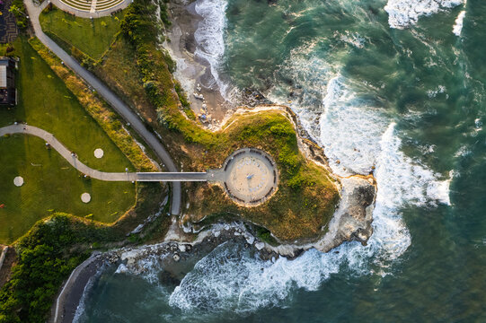 Aerial view of the dramatic coastline where the sea crashes against the rocks near a park with winding pathways, Sunclock, Lozenets, Tsarevo, Bulgaria.