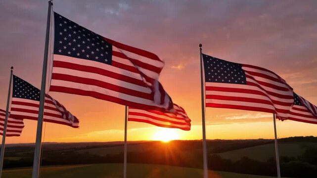 Multiple american flags flying at sunset over rolling hills