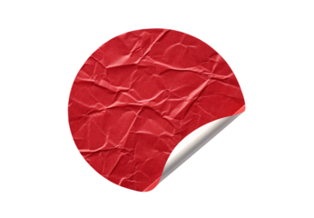 Red crumpled paper circular sticker with curled corner edge, isolated on a transparent background
