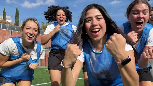 Successful female soccer team celebrating victory together